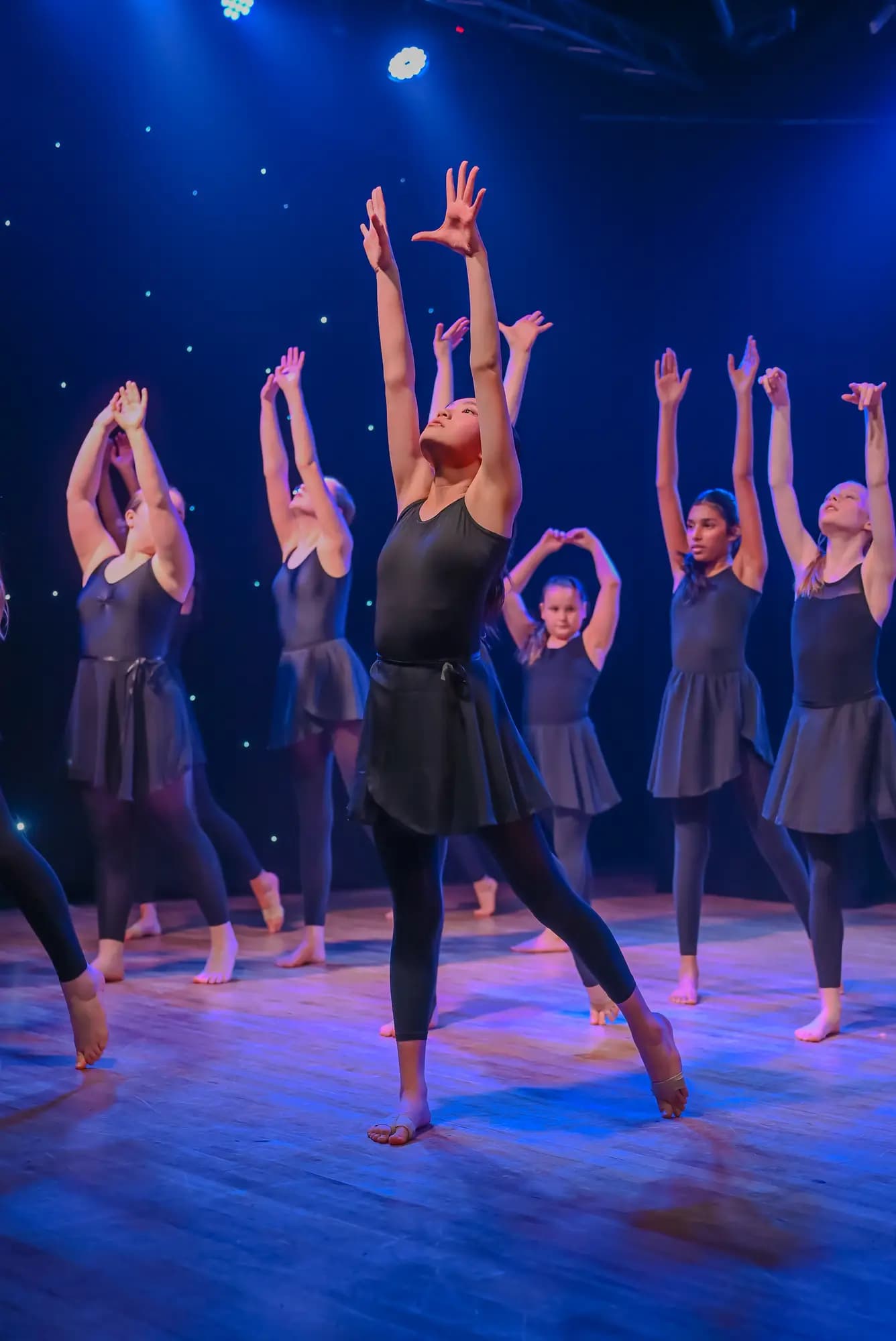 Contemporary ensemble reaching skyward in unison
