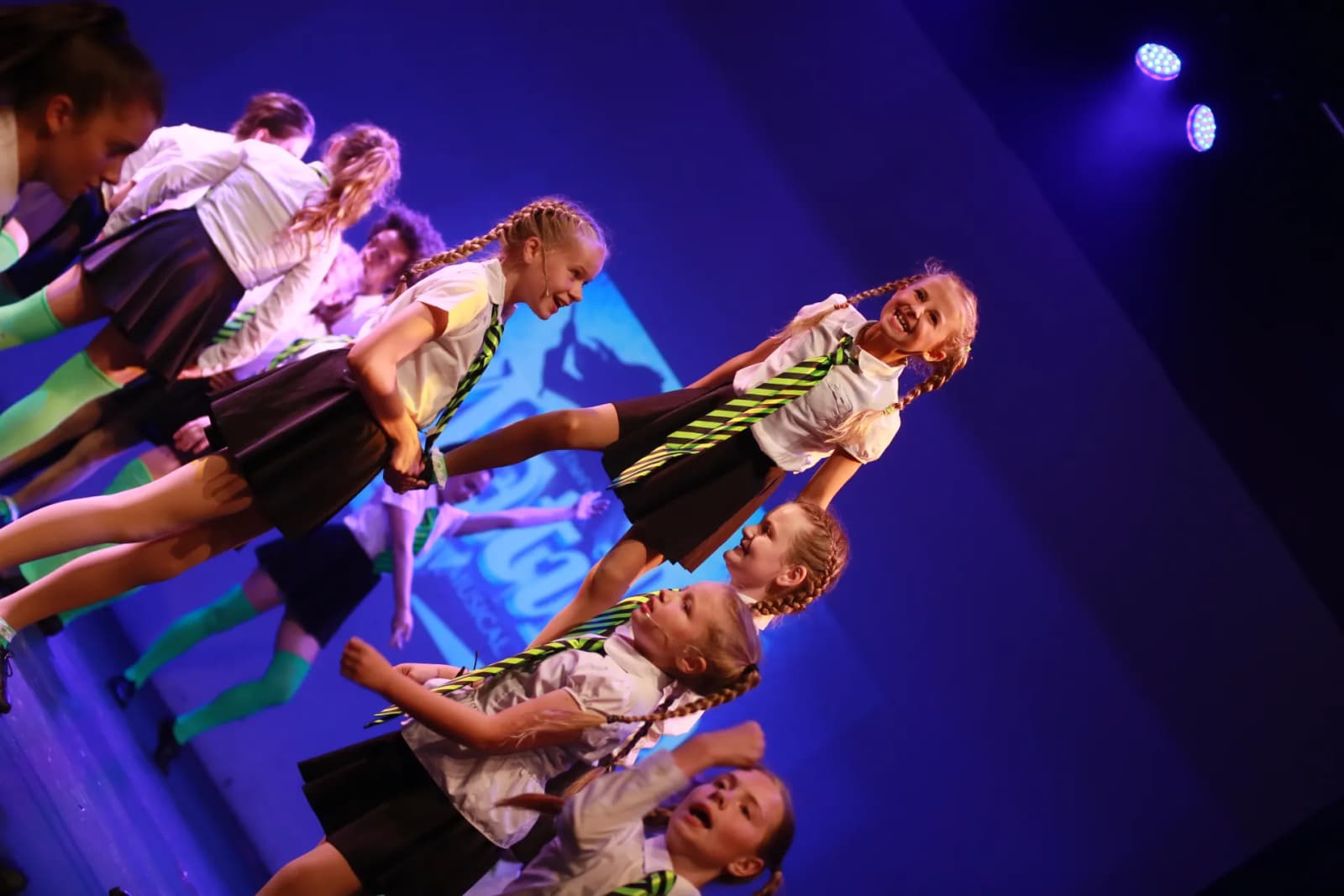 Star-Struck cast in a schoolgirl-uniform ensemble number on stage